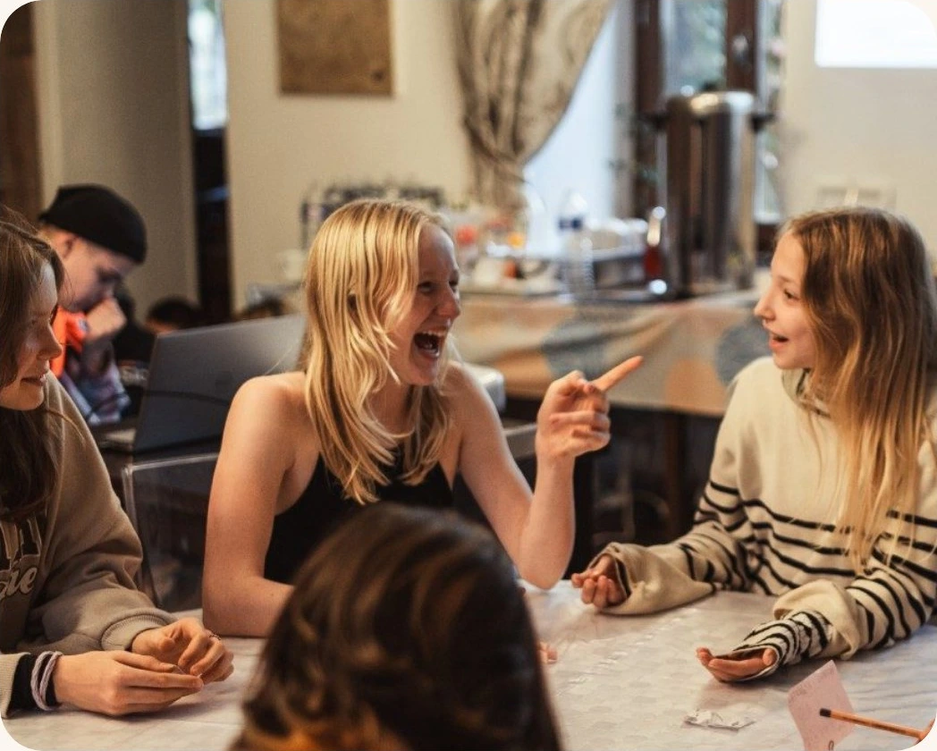 Campers discussing a problem around a table