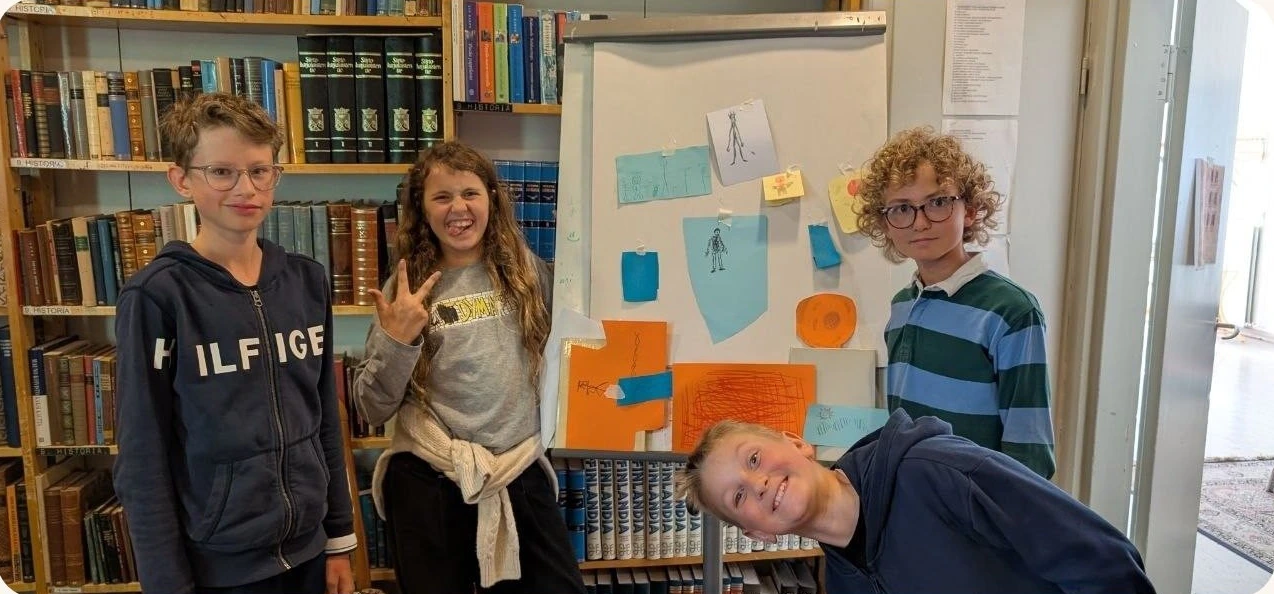 A team presenting their work at the board